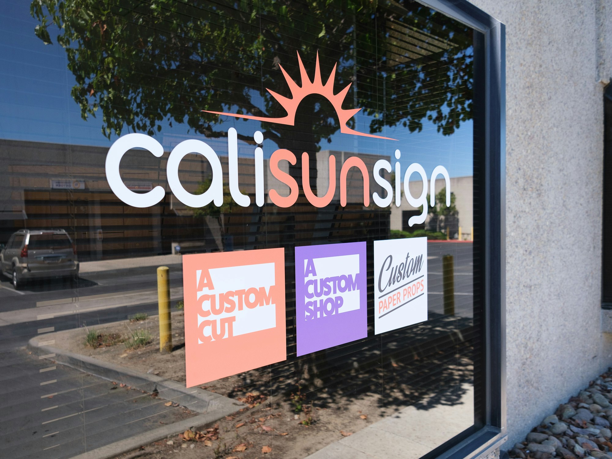 Front window of the showroom with vinyl logos